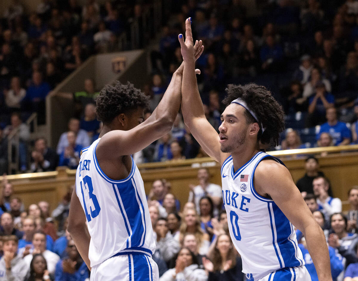 Duke’s Sean Stewart high fives teammate Jared McCain after he drew a foul during the first half of the Blue Devils’ 109-64 exhibition win over UNC Pembroke on Wednesday, Nov. 1, 2023, at Cameron Indoor Stadium in Durham, N.C.