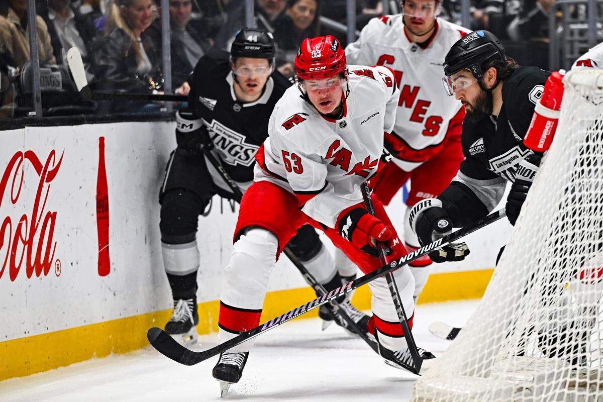 Mar 22, 2025; Los Angeles, California, USA; Carolina Hurricanes right wing Jackson Blake (53) fights for the puck against Los Angeles Kings defenseman Drew Doughty (8) during the first period at Crypto.com Arena. Mandatory Credit: Jonathan Hui-Imagn Images