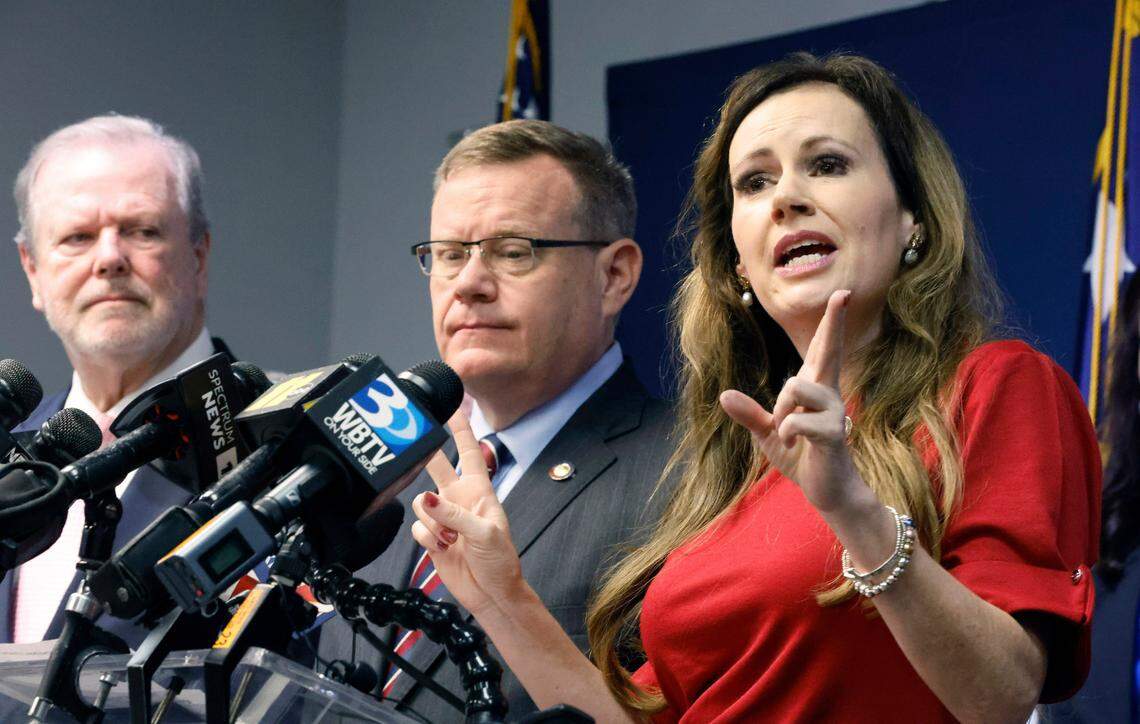 N.C. Senate leader Phil Berger, left, and House Speaker Tim Moore, center, look on as N.C. Rep. Tricia Cotham speaks during a press conference Wednesday, April 5, 2023. The press conference was to announce Rep. Cotham is switching parties to become a member of the House Republican caucus.