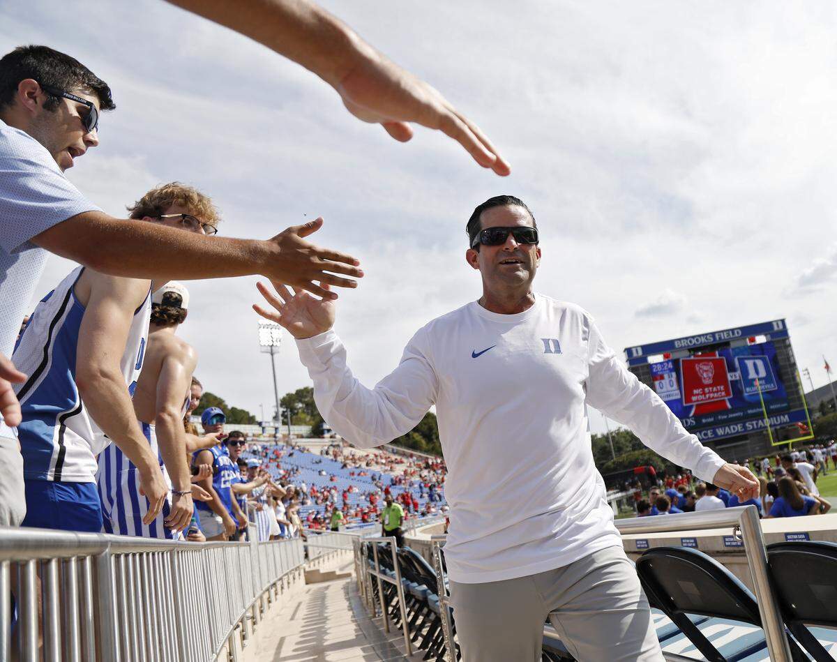 Duke head coach Manny Diaz high fives fans prior to the Blue Devils’ game against N.C. State on Saturday, Sept. 20, 2025, at Wallace Wade Stadium in Durham, N.C.