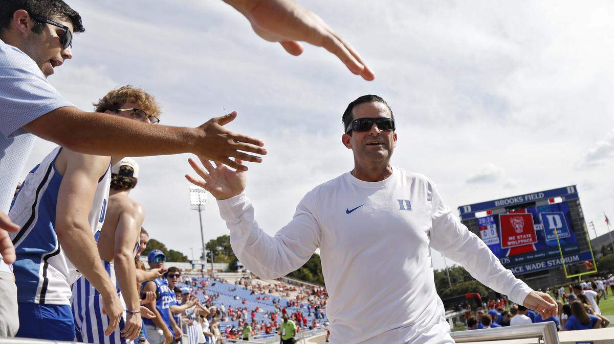 Duke head coach Manny Diaz high fives fans prior to the Blue Devils’ game against N.C. State on Saturday, Sept. 20, 2025, at Wallace Wade Stadium in Durham, N.C.