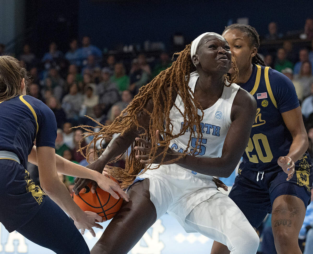 North Carolina’s Maria Gakdeng drives between Notre Dame’s Sonia Citron and Liatu King during the first half of the Tar Heels’ 76-66 loss on Sunday, Jan. 5, 2025, at Carmichael Arena in Chapel Hill, N.C.