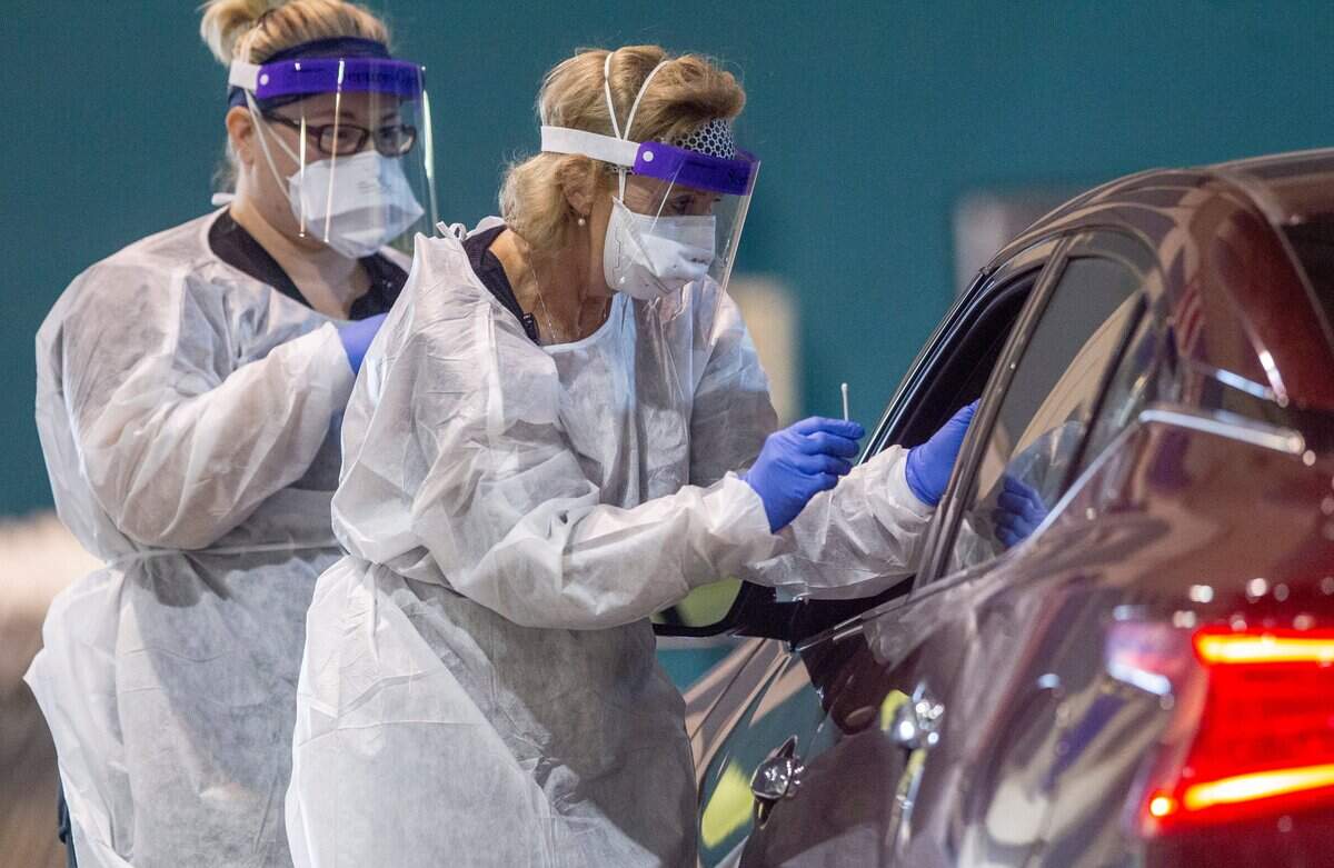 Caroline Barrett, LPN, left, and Teresa Holland, FNP, of Goshen Medical Center, perform coronavirus tests at the Duplin County Events center in Kenansville Wednesday, May 20, 2020.