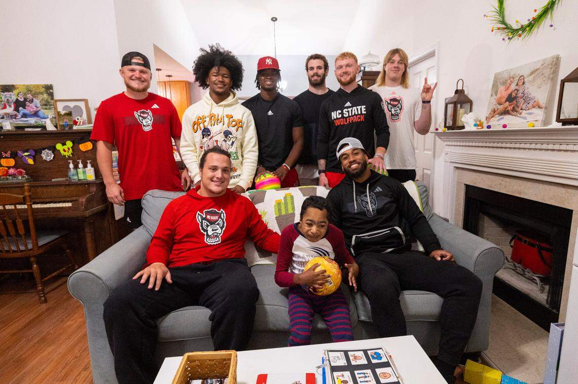 Grayson Ketchie, 12, poses with N.C. State football players who paid a surprise visit to Ketchie’s home in Garner Wednesday, Oct. 18, 2023. Next to Grayson is Dylan McMahon, left, and Trent Pennix. In the top row, from left, stand Brayden Narveson, KC Concepcion, MJ Morris, Payton Wilson, Brennan Armstrong and Dawson Jaramillo.
