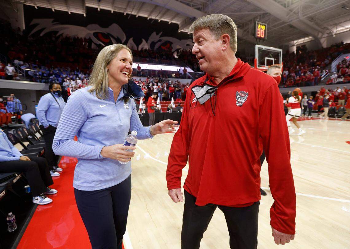 North Carolina head coach Courtney Banghart talks with N.C. State head coach Wes Moore before N.C. States game against UNC at Reynolds Coliseum in Raleigh, N.C., Thursday, January 6, 2022.