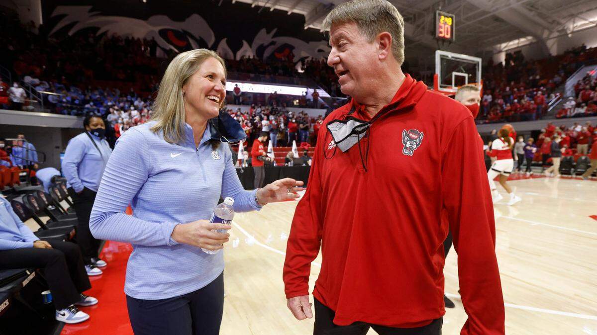 North Carolina head coach Courtney Banghart talks with N.C. State head coach Wes Moore before N.C. States game against UNC at Reynolds Coliseum in Raleigh, N.C., Thursday, January 6, 2022.