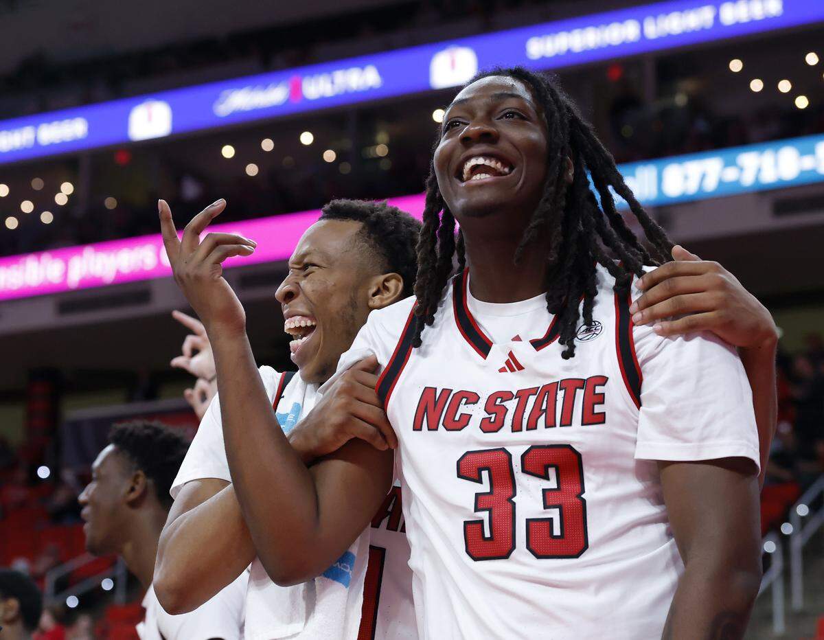 N.C. State’s Quadir Copeland and Zymicah Wilkins react on the bench in the closing minutes of N.C. State’s 110-64 win over UNC Greensboro on Wednesday, Nov. 12, 2025, at Lenovo Center in Raleigh, N.C.