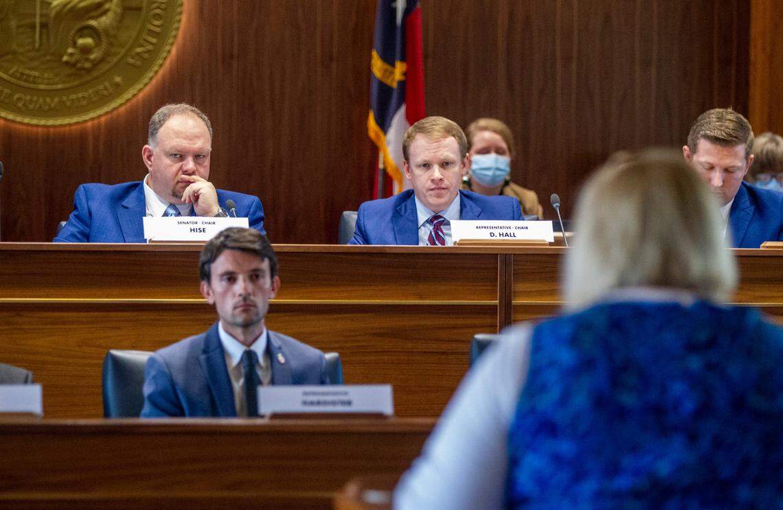 Top state redistricting legislators, Sen. Ralph Hise, top left, and Rep. Destin Hall, top right, listen as several dozen members of the public address state lawmakers during a public comment hearing on Senate and House legislative redistricting maps Monday, Oct. 15, 2021 at the Legislative Building in Raleigh.