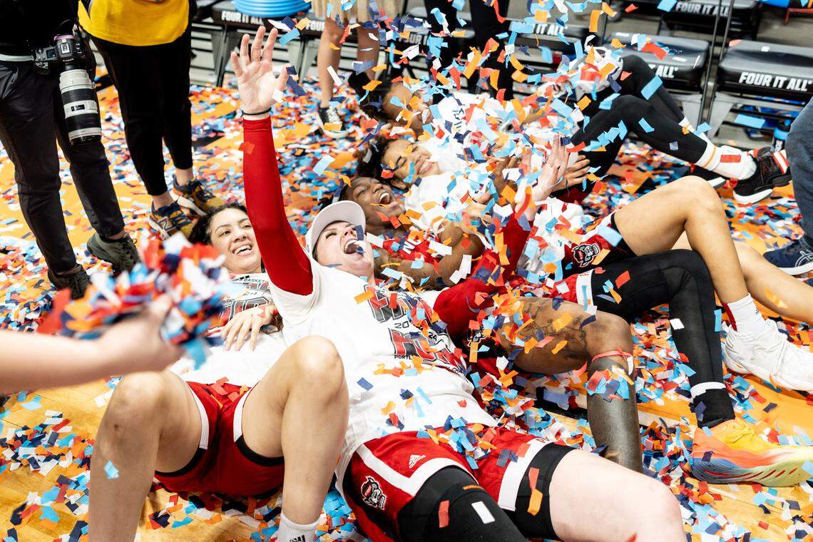 NC State women’s basketball players celebrate after defeating Texas and earning a spot in the NCAA Final Four.