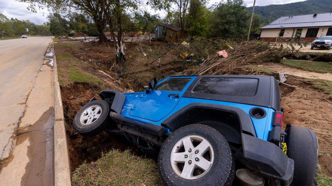 A Jeep, swept from the road by floodwaters, lies in a creek in Swannanoa on Sunday, Sept. 29, 2024. The remnants of Hurricane Helene caused widespread flooding, downed trees, and power outages in western North Carolina.