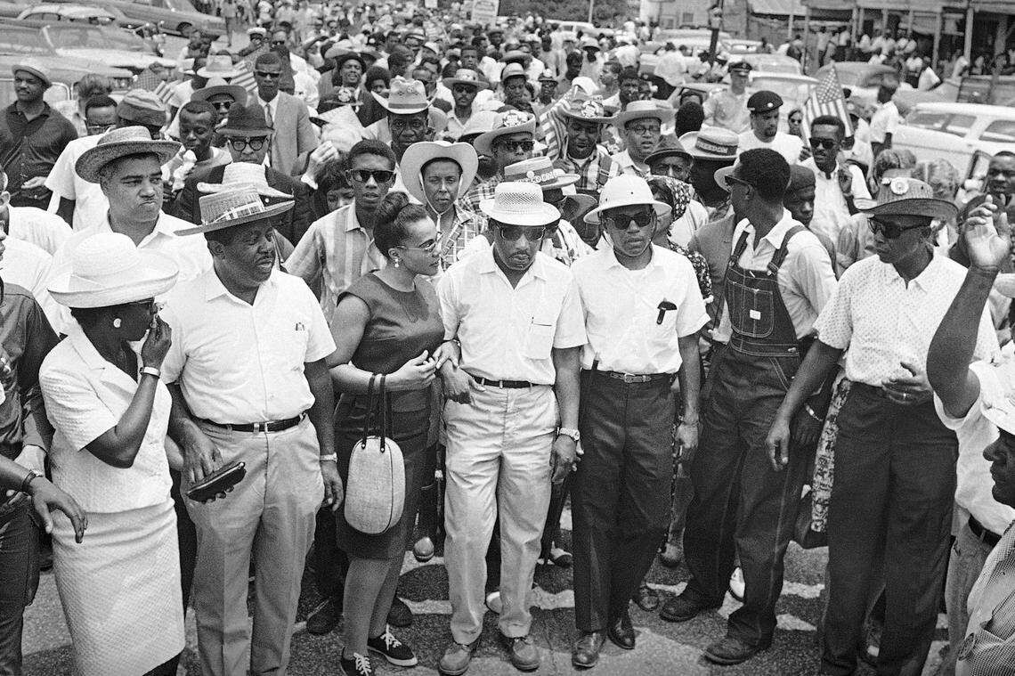 In this June 26, 1966, file photo, thousands of civil rights marchers assemble for the last leg of the Mississippi March from Tougaloo College north of Jackson, Mississippi, to the Capitol. In the front row, from left are: Juanita Abernathy, the Rev. Ralph Abernathy, Coretta Scott King, the Rev. Martin Luther King, James Meredith, Stokely Carmichael of the Student Non-Violent Coordinating Committee (looking back) and Floyd McKissick, national director of the Congress of Racial Equality.