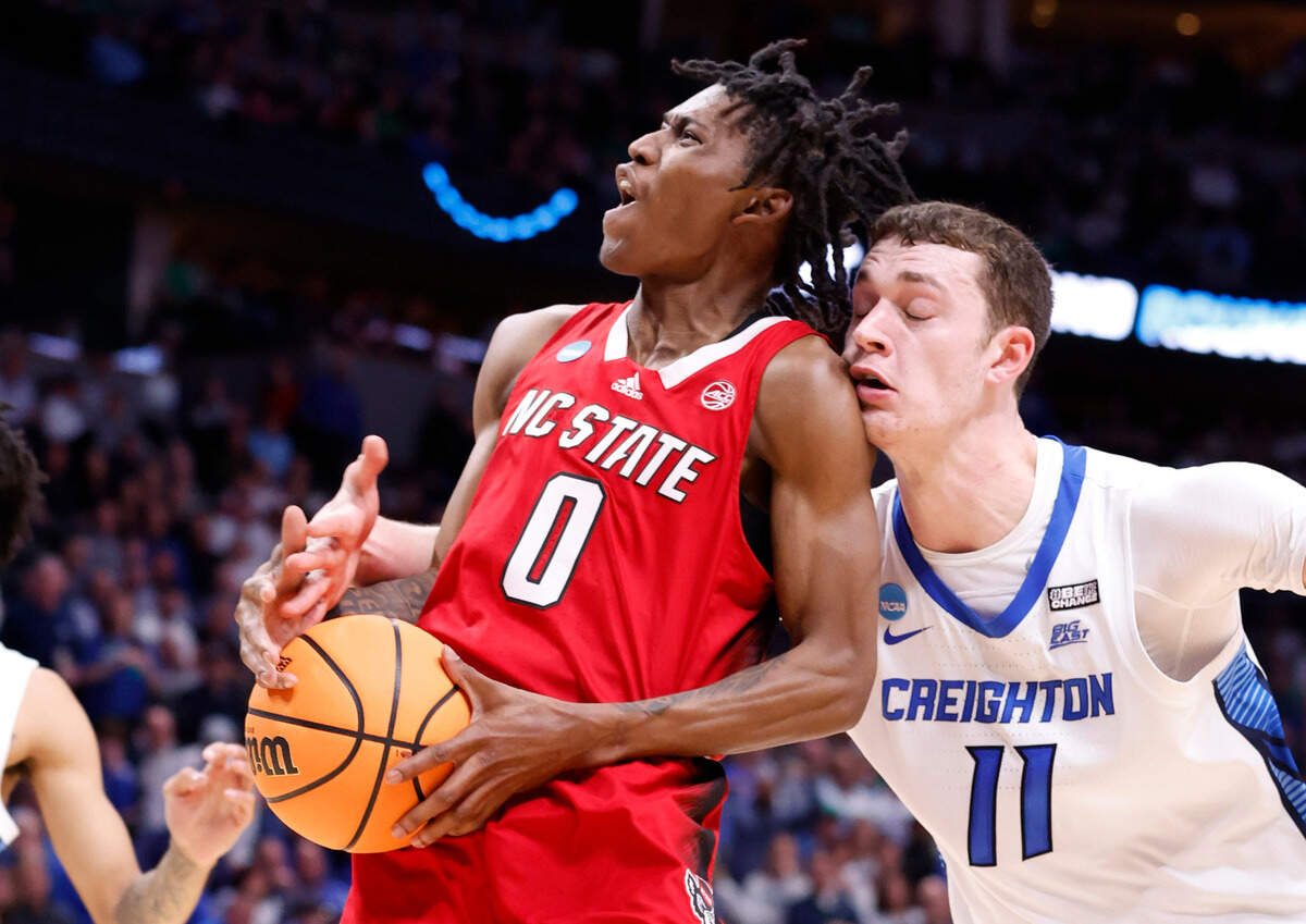 Creighton’s Ryan Kalkbrenner (11) fouls N.C. State’s Terquavion Smith (0) during the second half of Creighton’s 72-63 victory over N.C. State in the first round of the NCAA Tournament at Ball Arena in Denver, Colo., Friday, March 17, 2023.