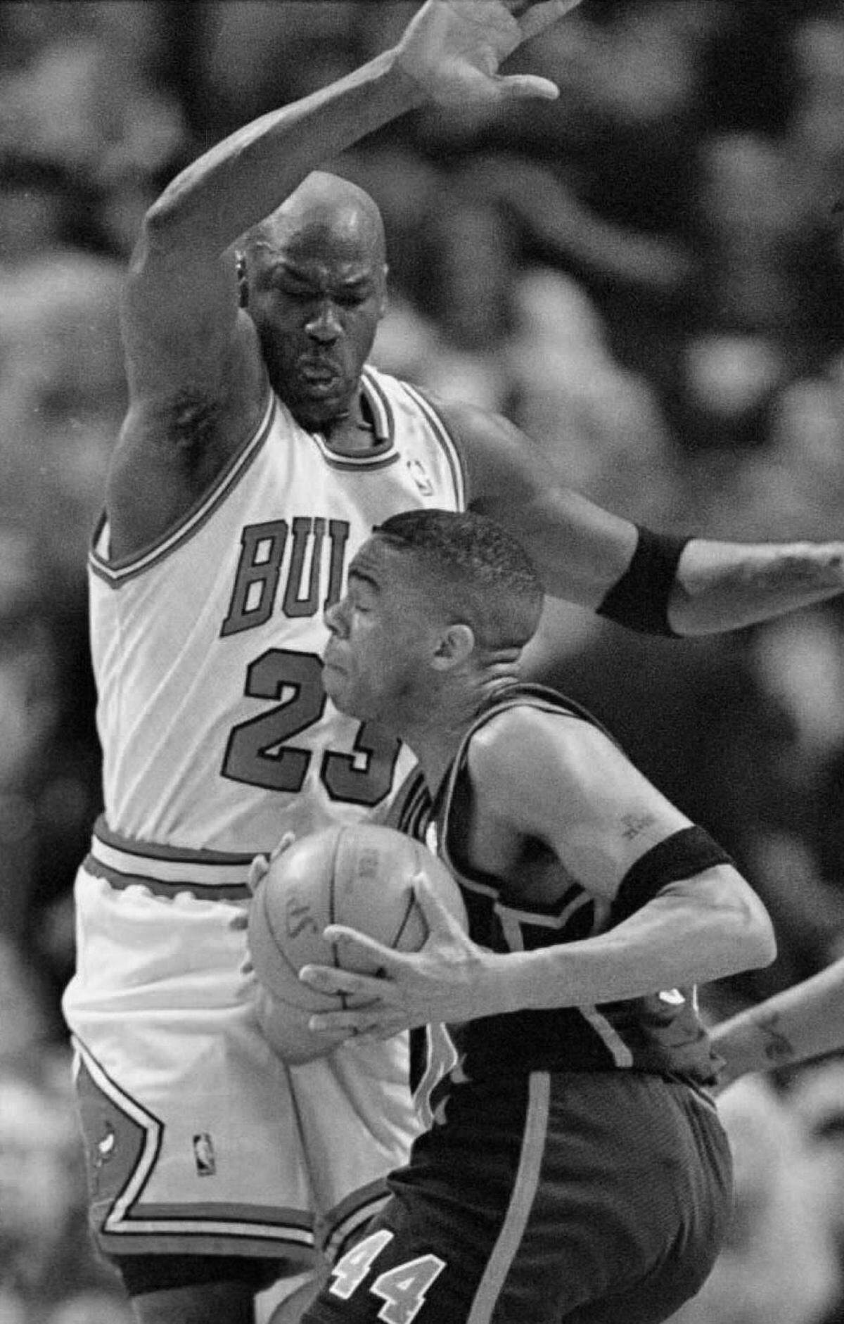 Michael Jordan of the Chicago Bulls defends against a drive by New York Knicks guard Hubert Davis in 1996.