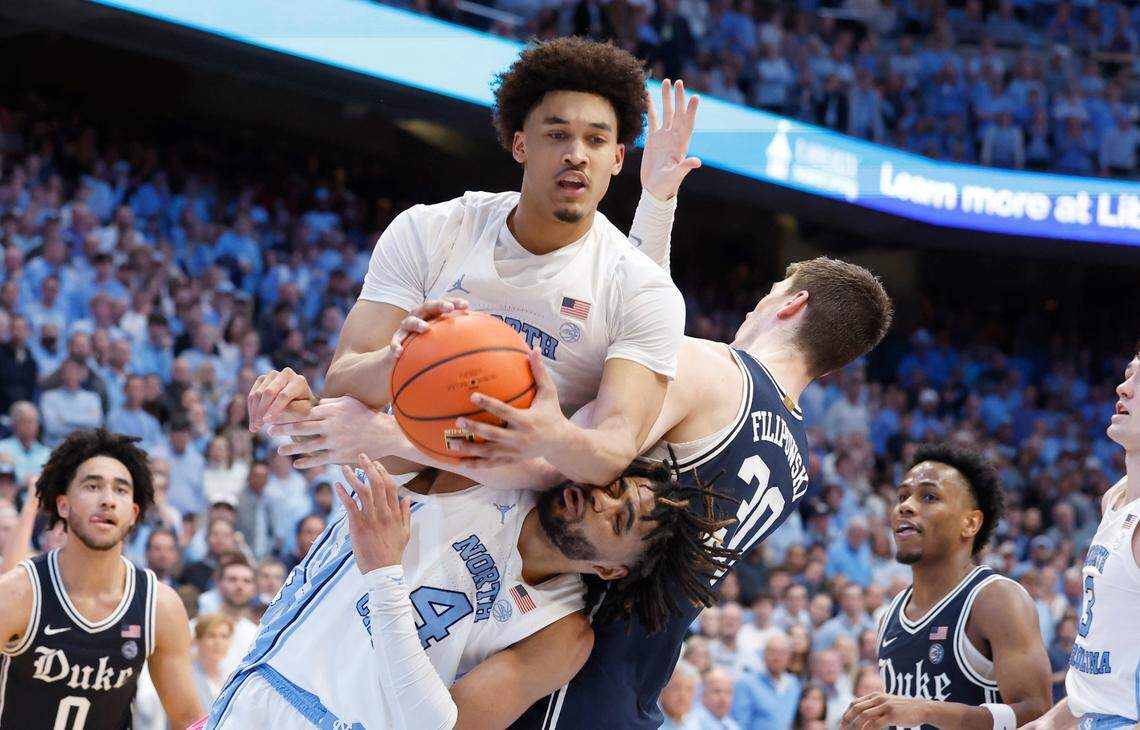 North Carolina’s RJ Davis (4) is called for the flagrant foul as he tangles up with Duke’s Kyle Filipowski (30) as North Carolina’s Seth Trimble (7) pulls in the rebound during the second half of UNC’s 93-84 victory over Duke at the Smith Center in Chapel Hill, N.C., Saturday, Feb. 3, 2024.