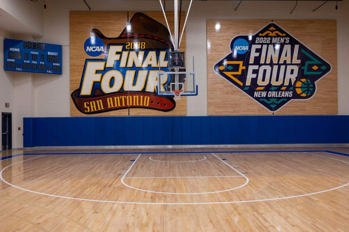 Inside the University of Kansas’ basketball practice facility, two of the courts from their National Championships cover one wall on Thursday, November 7, 2024 in Lawrence, Kansas. Both of those Final Fours included defeats of North Carolina by the Jayhawks.