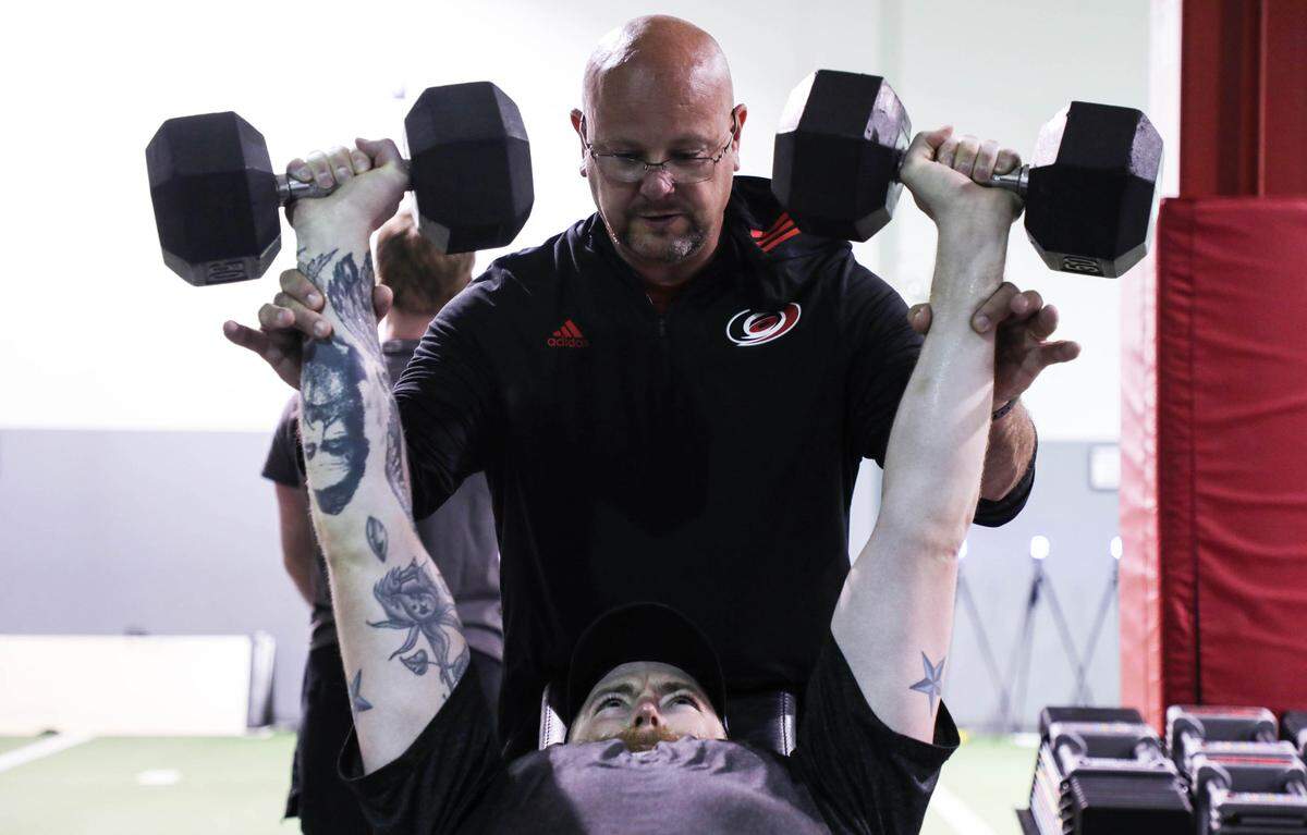 Bill Burniston, head strength and conditioning coach for the Carolina Hurricanes, works with goalie Scott Darling during a workout at The Performance Academy at Raleigh Orthopedic on Monday July 2, 2018.