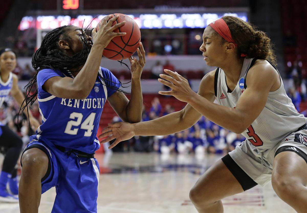 Kentucky’s Taylor Murray (24) grabs the ball while North Carolina State’s Kai Crutchfield (3) defends during the first half of a second round women’s college basketball game in the NCAA Tournament in Raleigh, N.C., Monday, March 25, 2019.