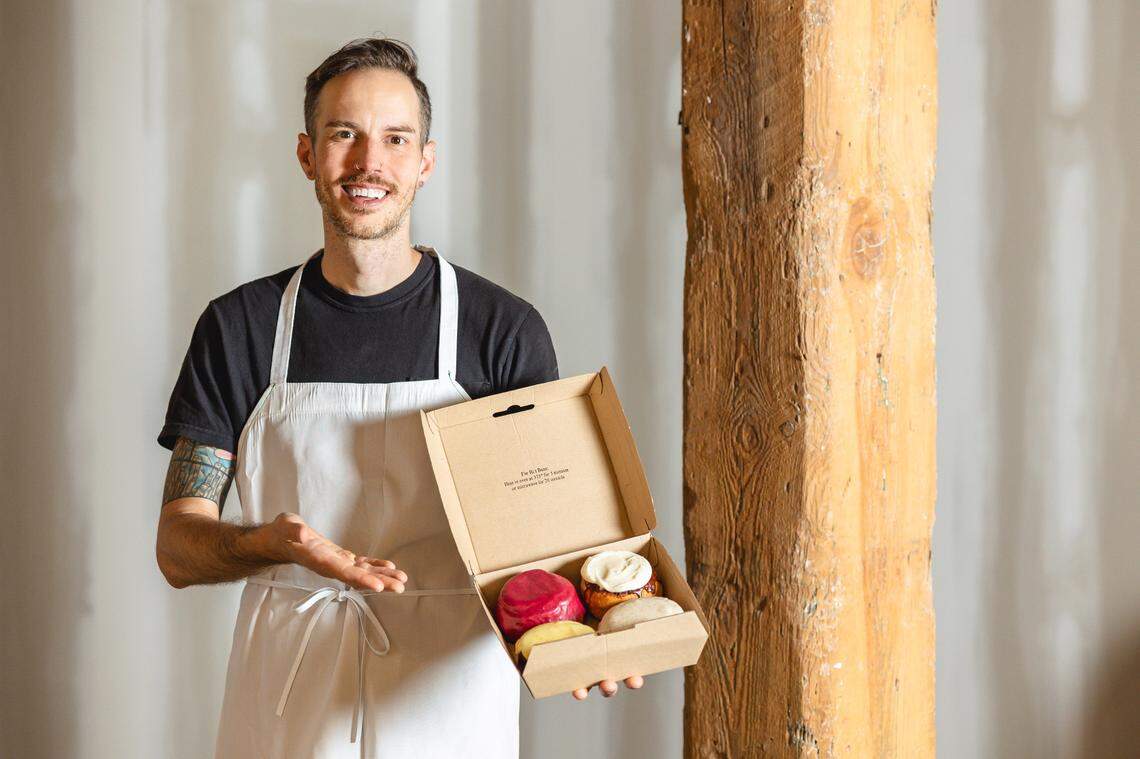 Lutra Cafe and Bakery chef-owner Chris McLaurin holds a box of buns, the baked goods his bakery is most known for.