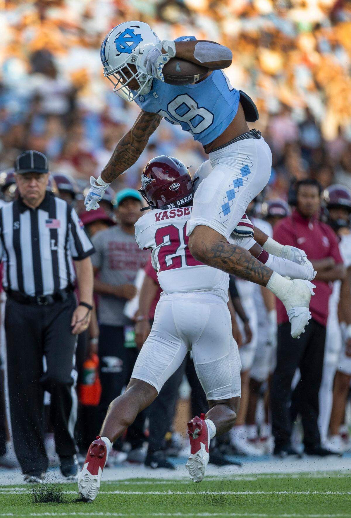 North Carolina running back Omarion Hampton (28) hurdles over N.C. Central defensive back Jelani Vessell (28) in the first quarter on Saturday, September 14, 2024 at Kenan Stadium in Chapel Hill, N.C.