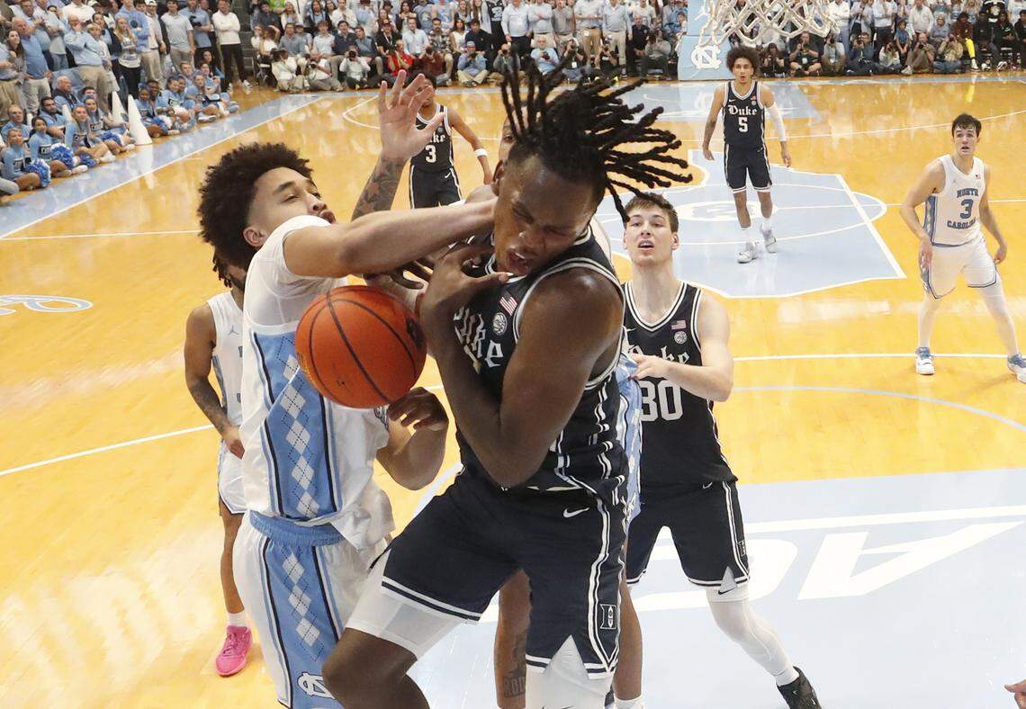 Duke’s Mark Mitchell (25) and North Carolina’s Seth Trimble (7) battle for a rebound during UNC’s 93-84 victory over Duke at the Smith Center in Chapel Hill, N.C., Saturday, Feb. 3, 2024.