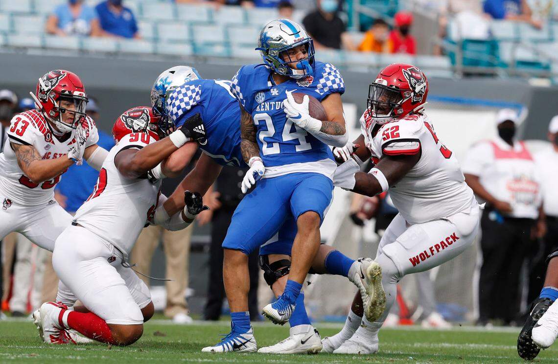 Kentucky running back Chris Rodriguez Jr. (24) spins around the Wolfpack defense during the first half of N.C. State’s game against Kentucky in the Gator Bowl at TIAA Bank Field in Jacksonville, Fla., Saturday, January 2, 2021.