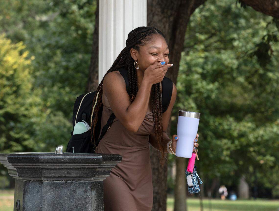 First-year student Malkiah Morris of Charlotte, N.C. reacts after drinking from the Old Well on the first day of classes at UNC-Chapel Hill on Monday, Aug. 21, 2023.
