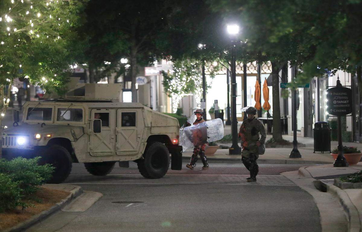 Members of the North Carolina National Guard stand guard at North Hills Mall early Monday morning, June 1, 2020.