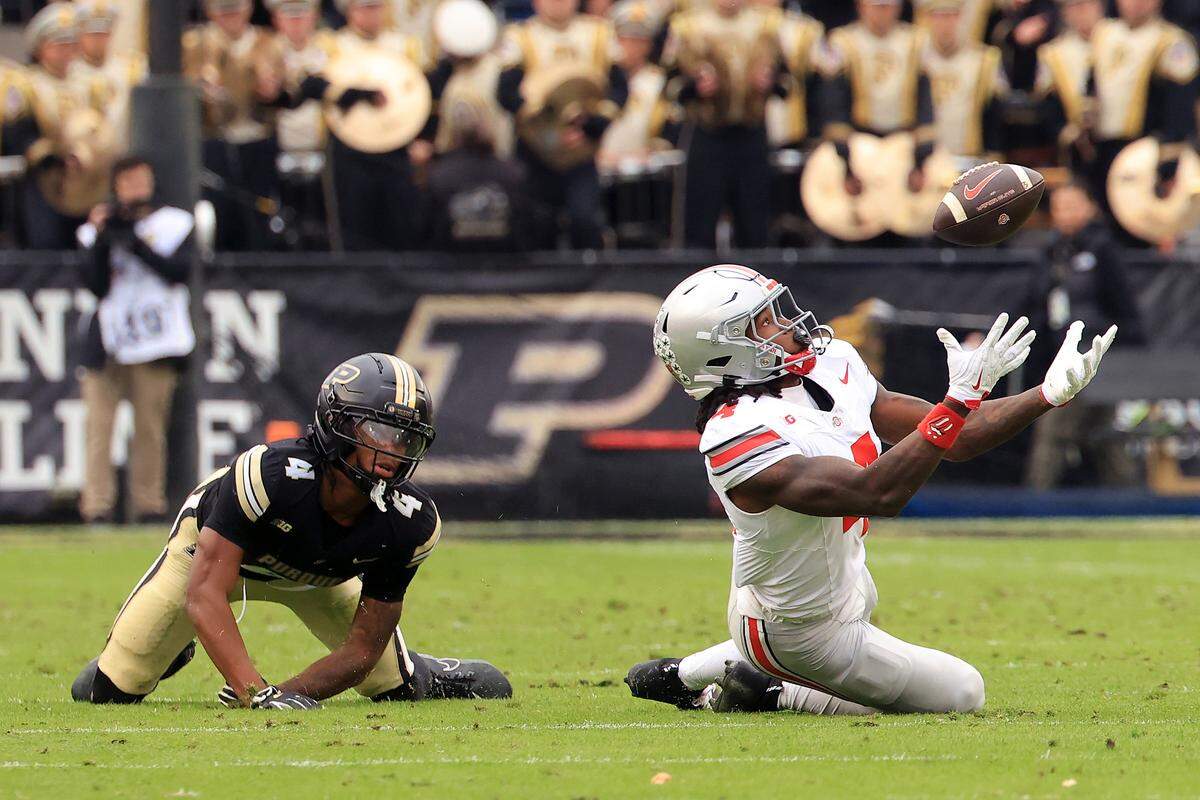 Jeremiah Smith, right, of the Ohio State Buckeyes, makes a catch while being defended by Hudauri Hines of the Purdue Boilermakers during the first quarter at Ross-Ade Stadium on Nov. 8, 2025 in West Lafayette, Indiana. 