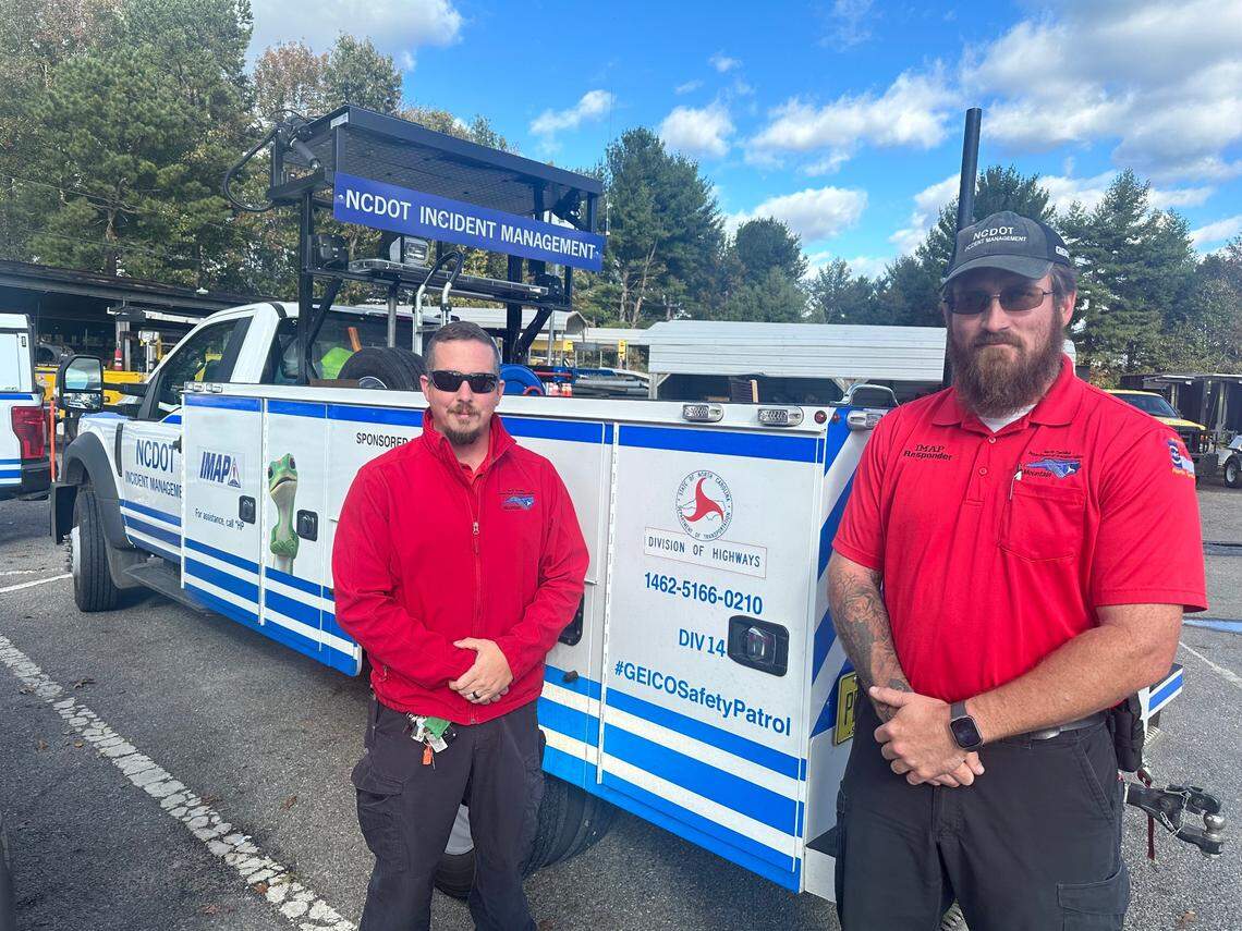 Garret McFalls, left, and Christopher Strader, stand in front of an incident management or IMAP truck. McFalls and Strader drive IMAP trucks for the N.C. Department of Transportation and were among those who helped get traffic off Interstate 40 before sections fell into the Pigeon River.