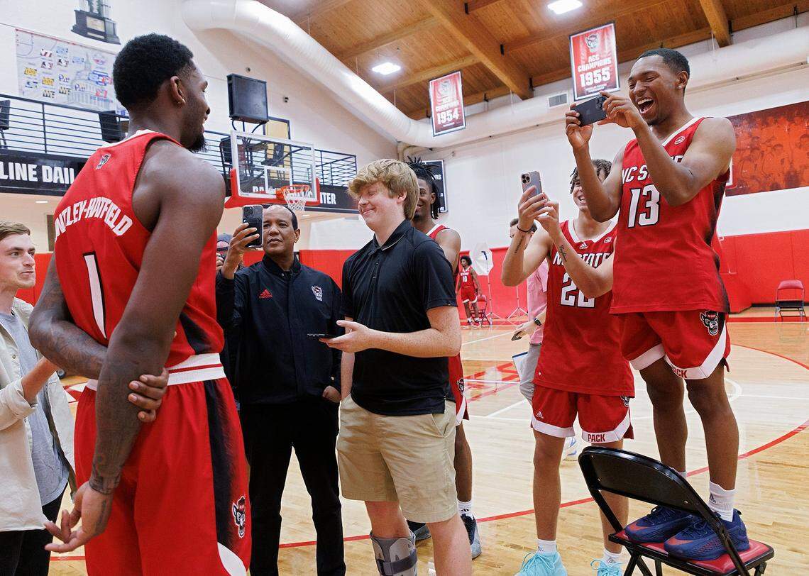 N.C. State’s KJ Keatts, right, laughs while recording teammate Brandon Huntley-Hatfield during media day for the N.C. State men’s basketball team on Thursday, Sept. 19, 2024, in Raleigh, N.C.