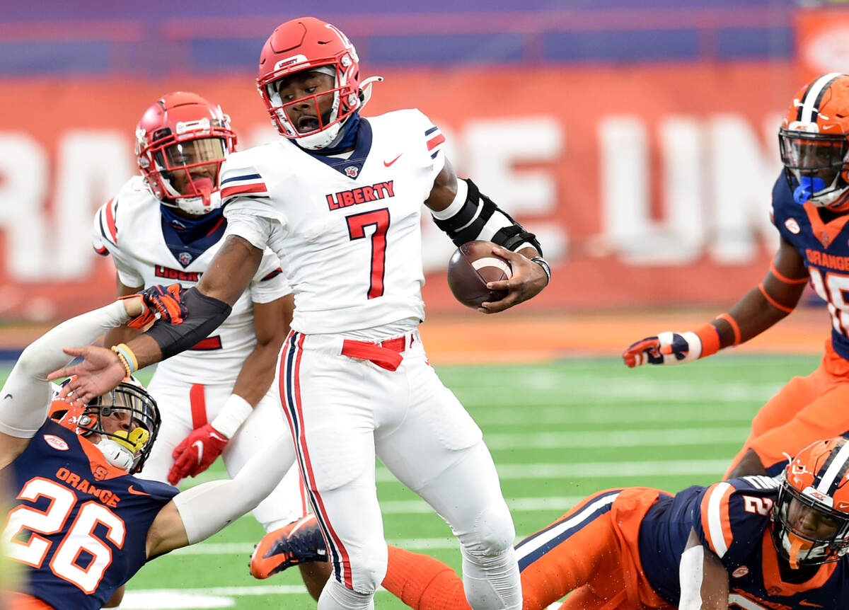 Liberty Flames quarterback Malik Willis (7) evades Syracuse defenders during their game on Saturday, Oct. 17, 2020, at the Carrier Dome in Syracuse, N.Y.