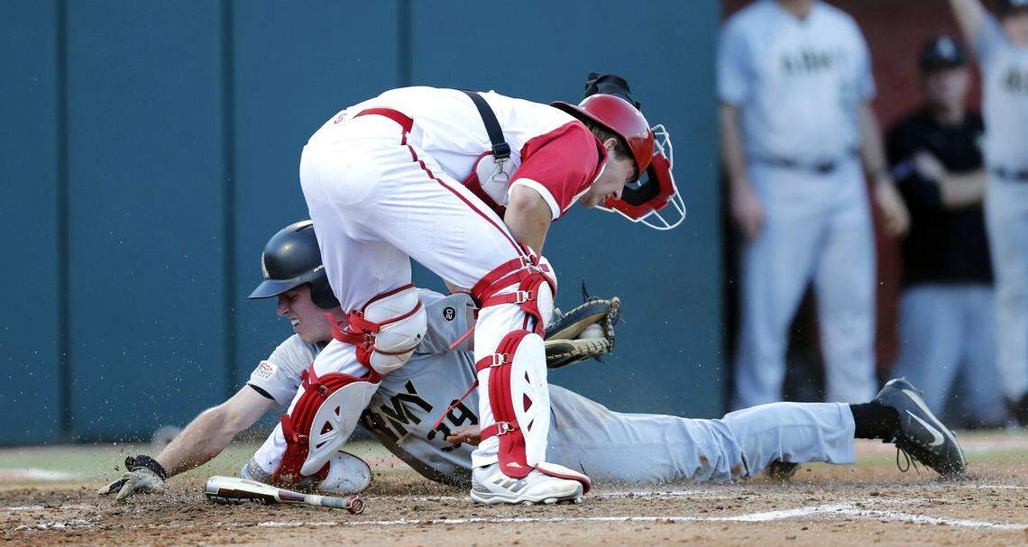 Army's Jacob Hurtubise (39) slides in safe as N.C. State's Patrick Bailey (5) makes the tag during Army's 5-1 victory over N.C. State in the Raleigh Regional at Doak Field in Raleigh, N.C., on Friday, June 1, 2018.
