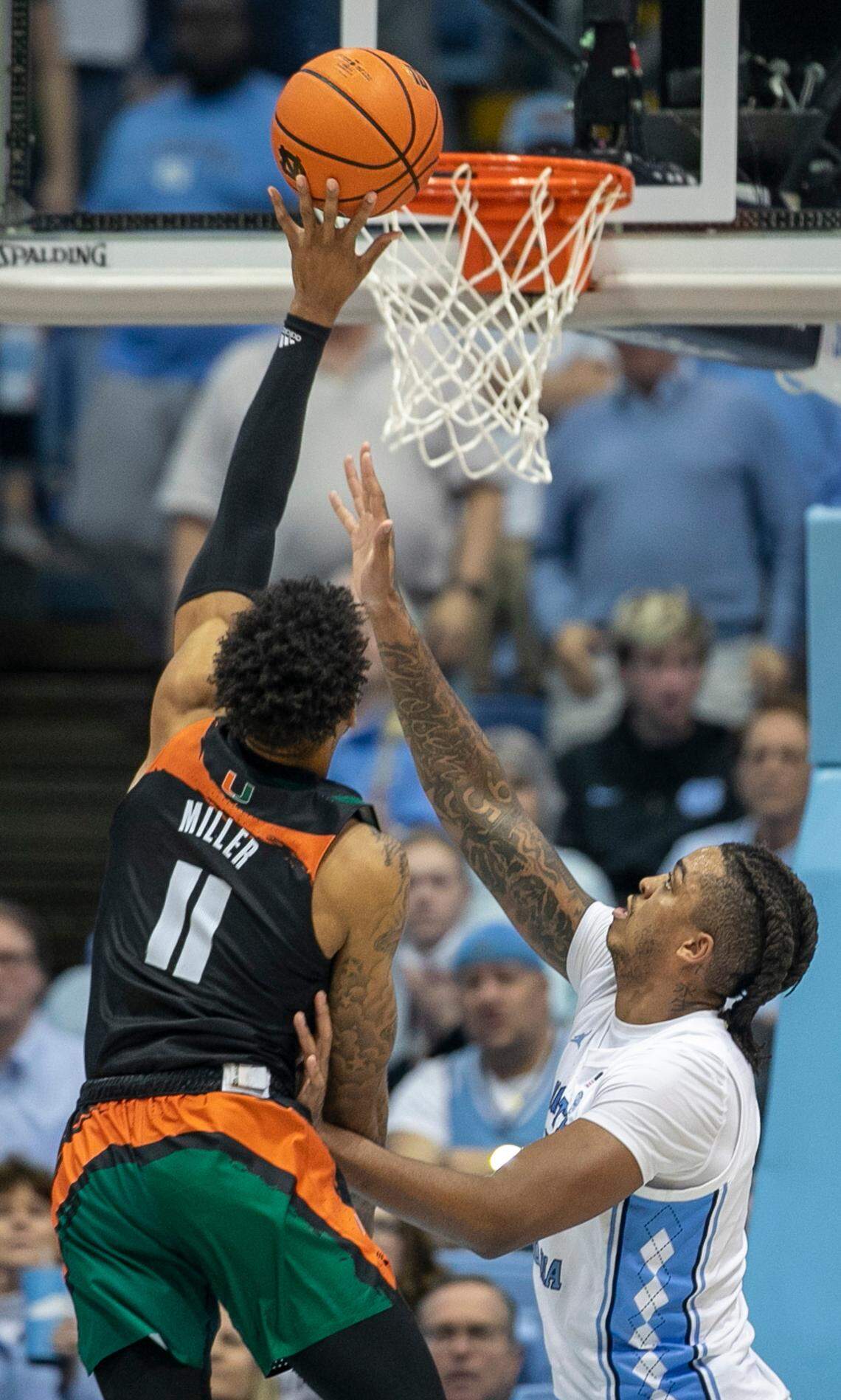 Miami’s Jordan Miller (11) drives to the basket against North Carolina’s Armando Bacot (5) in the second half on Monday, February 13, 2023 at the Smith Center in Chapel Hill, N.C. Miller lead all scores with 24 points in Miami’s 80-762 victory.