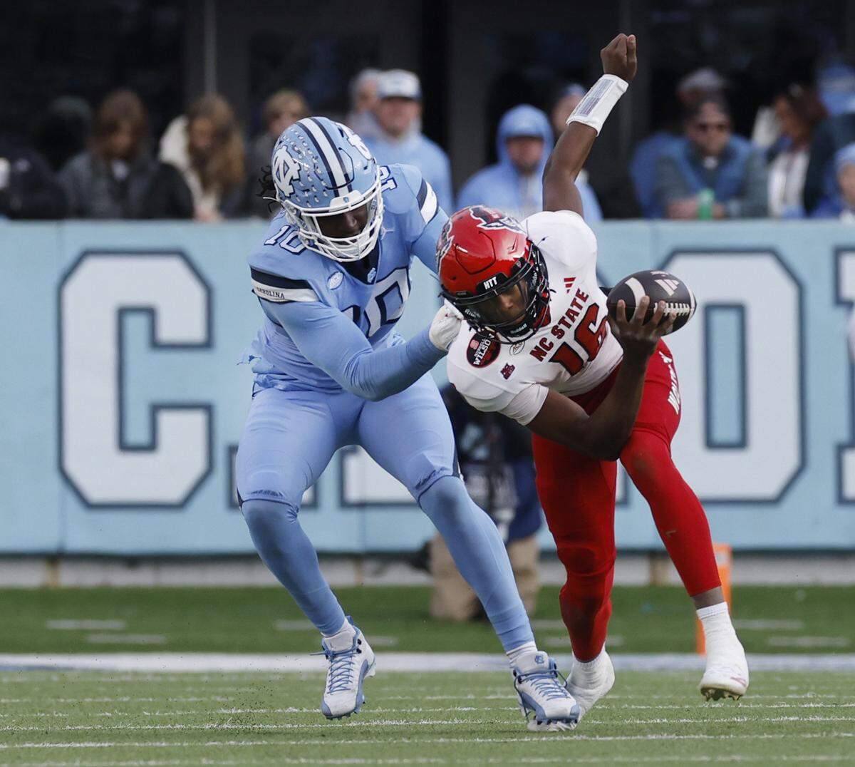 North Carolina defensive lineman Desmond Evans (10) sacks N.C. State quarterback CJ Bailey (16) during the first half of N.C. State’s game against UNC at Kenan Stadium in Chapel Hill, N.C., Saturday, Nov. 30, 2024.