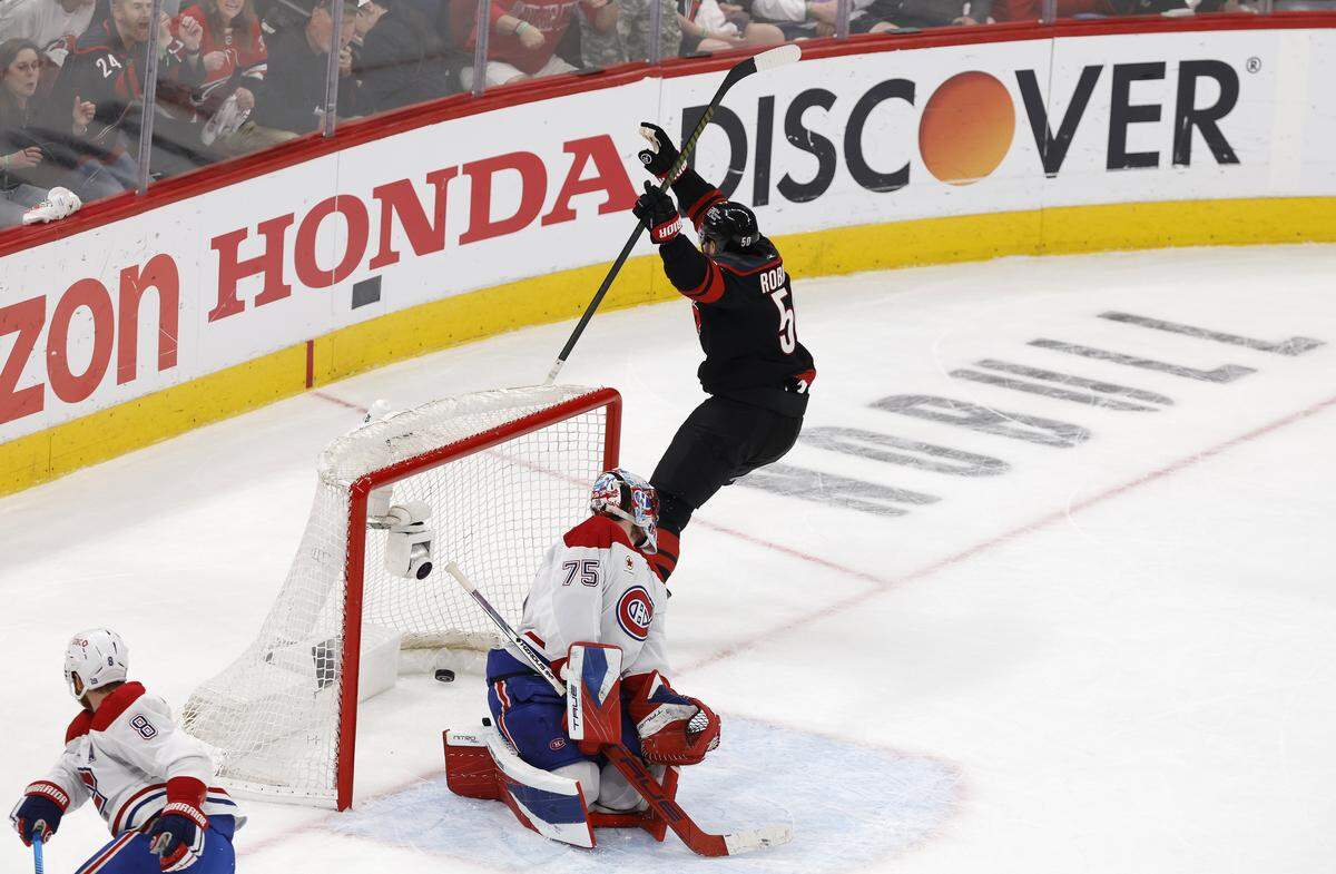 Carolina's Eric Robinson (50) celebrates scoring on Montréal's Jakub Dobes (75) during the first period of the Hurricanes’ game against the Canadiens in game five of the Eastern Conference Finals at the Lenovo Center Friday, May 29, 2026.