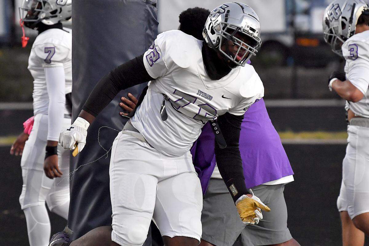 South Garner lineman Ekene Ogboko in pre-game drills before their game against Willow Spring. The Willow Spring Storm and the South Garner Titans met in a football game in Fuquay-Varina. N.C. on October 18, 2024.