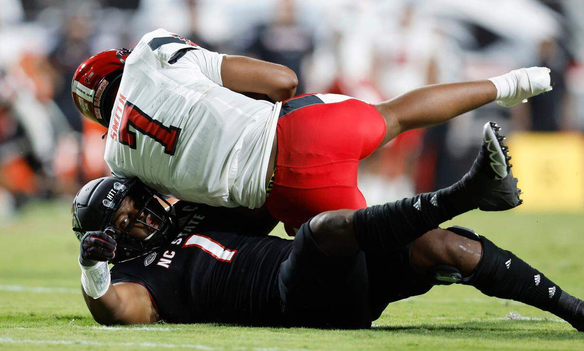 N.C. State linebacker Isaiah Moore (1) sacks Texas Tech quarterback Donovan Smith (7) during the first half of N.C. State’s game against Texas Tech at Carter-Finley Stadium in Raleigh, N.C., Saturday, Sept. 17, 2022.