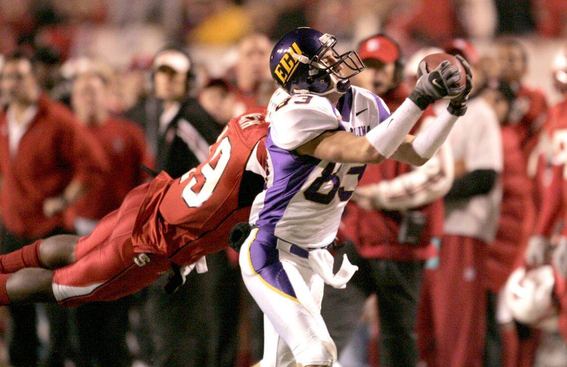 East Carolina’s Steven Rogers pulls in a 44-yard reception as N.C. State’s Garland Heath defends during East Carolina University’s 21-16 victory over the Wolfpack at Carter-Finley Stadium in 2006.