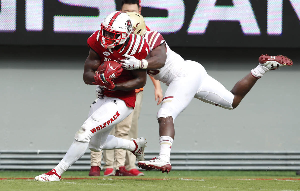 Late in the fourth quarter, on third and seven, N.C. State’s Stephen Louis (1) makes a 21-yard reception as Boston College’s linebacker John Lamot (28) defends, to effectively win the game during N.C. State’s 28-23 victory over Boston College at Carter-Finley Stadium in Raleigh, N.C., Saturday, Oct. 6, 2018.