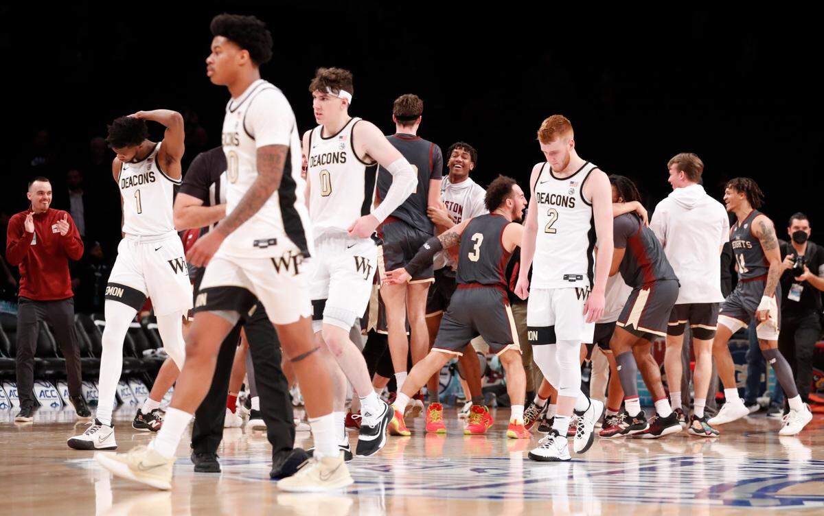 Wake Forest players, including Isaiah Mucius (1), Damari Monsanto (30), Jake LaRavia (0) and Cameron Hildreth (2) walk back to the bench area after Boston College’s 82-77 overtime victory over Wake Forest in the second day of the ACC men’s basketball tournament at the Barclays Center in Brooklyn, N.Y., Wednesday, March 9, 2022.