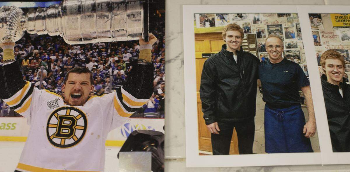 Mike’s Pastry owner Angelo Papa poses with Dougie Hamilton, right, on the wall of fame in the kitchen of the famous bakery in Boston’s North End. Hamilton became part of the Mike’s Pastry family when he played with the Boston Bruins.