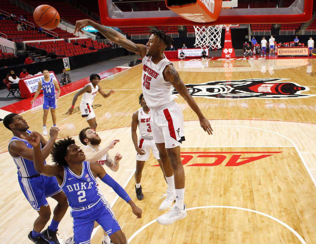 N.C. State’s Manny Bates (15) blocks the shot by Duke’s DJ Steward (2) during Duke’s 69-53 victory over N.C. State at PNC Arena in Raleigh, N.C., Saturday, February 13, 2021.