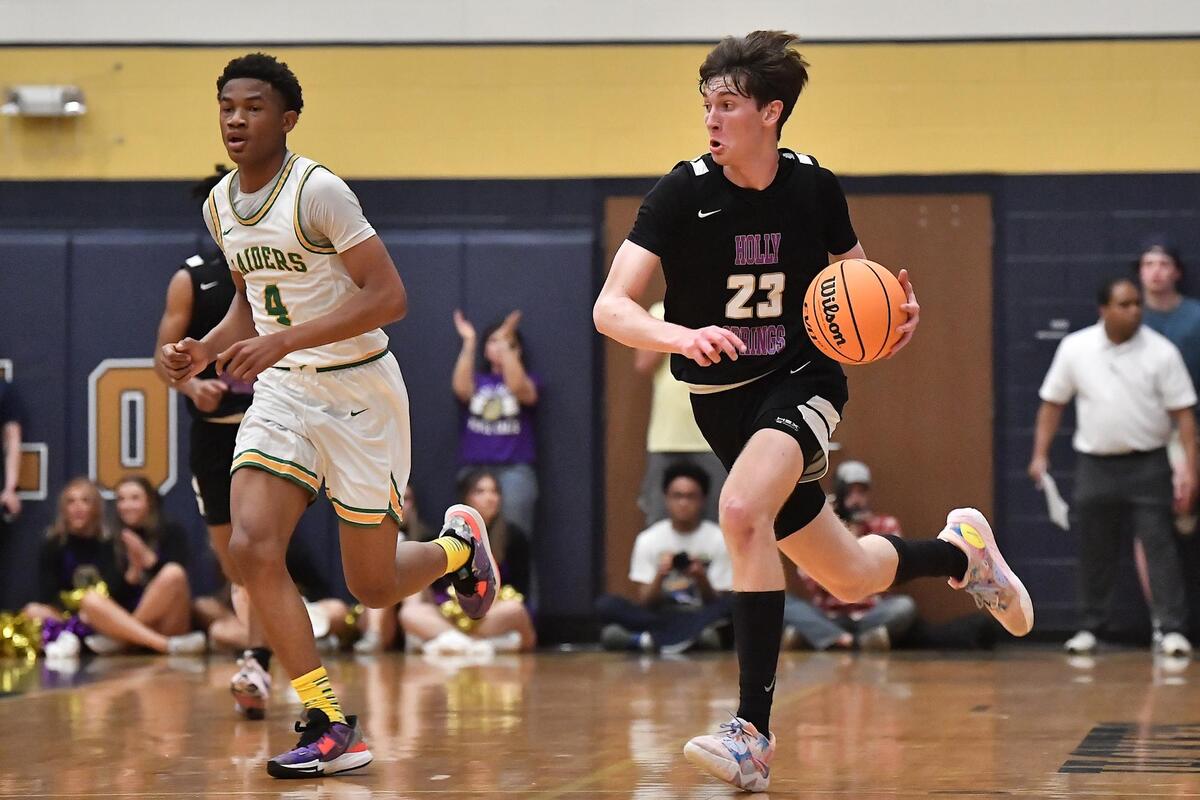 Holly Springs’ Ryan Crotty (23) drives the ball downcourt against Richmond’s Zion Baldwin (4) during the first half. The Richmond Raiders and the Holly Springs Golden Hawks met in the NCHSAA 4A East Regional Finals in Sanford, N.C. on March 4, 2023.