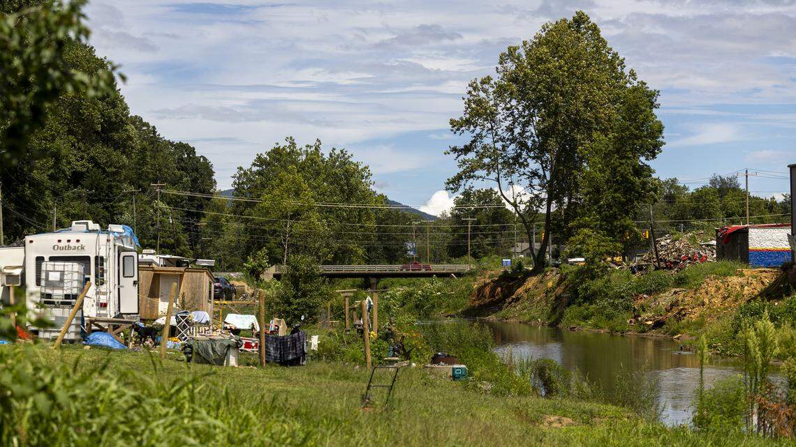 Debris and rubble still litter the riverbanks along the Swannanoa River and U.S. 70 in the unincorporated mountain community of Swannanoa in August. 