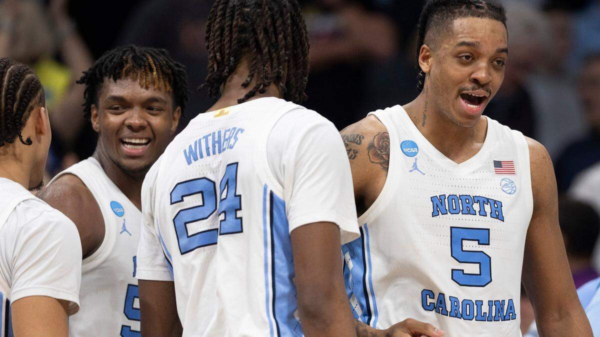 North Carolina’s Seth Trimble (7), Harrison Ingram (55), Jae’Lyn Withers (24) and Armando Bacot (5) celebrate the Tar Heels’ 85-69 victory over Michigan State on Saturday, March 23, 2024 in the second round of the NCAA Tournament at Spectrum Center in Charlotte, N.C.