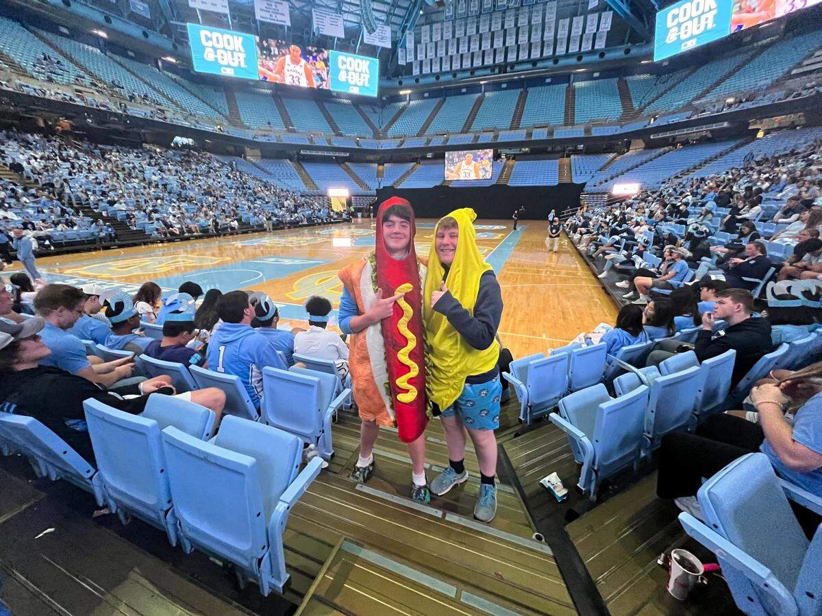 Finley Benton and Kessler Petrarca, 13-year-old best friends from Sanford, wear their good luck outfits at the Dean E. Smith Center in Chapel Hill, where they and several thousand other UNC Tar Heels fans gathered to watch Saturday’s game against Duke.