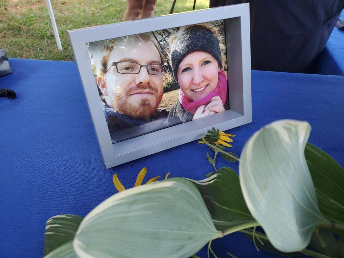 A framed photograph of Matt and Allison Simpson on display during Bike Durham’s memorial gathering for Matt Simpson on July 24, 2022. Matt was killed in a hit-and-run while riding his bike in Durham.