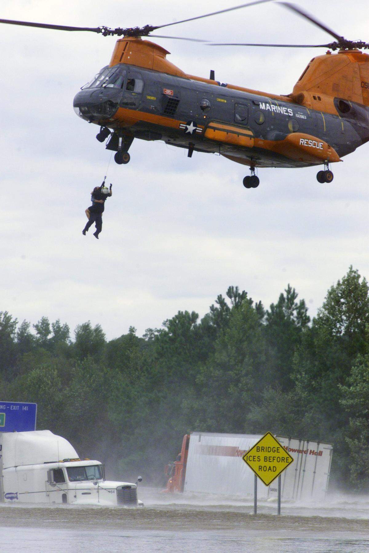 A helicopter rescues truck driver James Hammond, of Bridgeport,N.J.. from his flooded rig on Interstate 95 near Rocky Mount after his rig floated off the roadway during Hurricane Floyd.