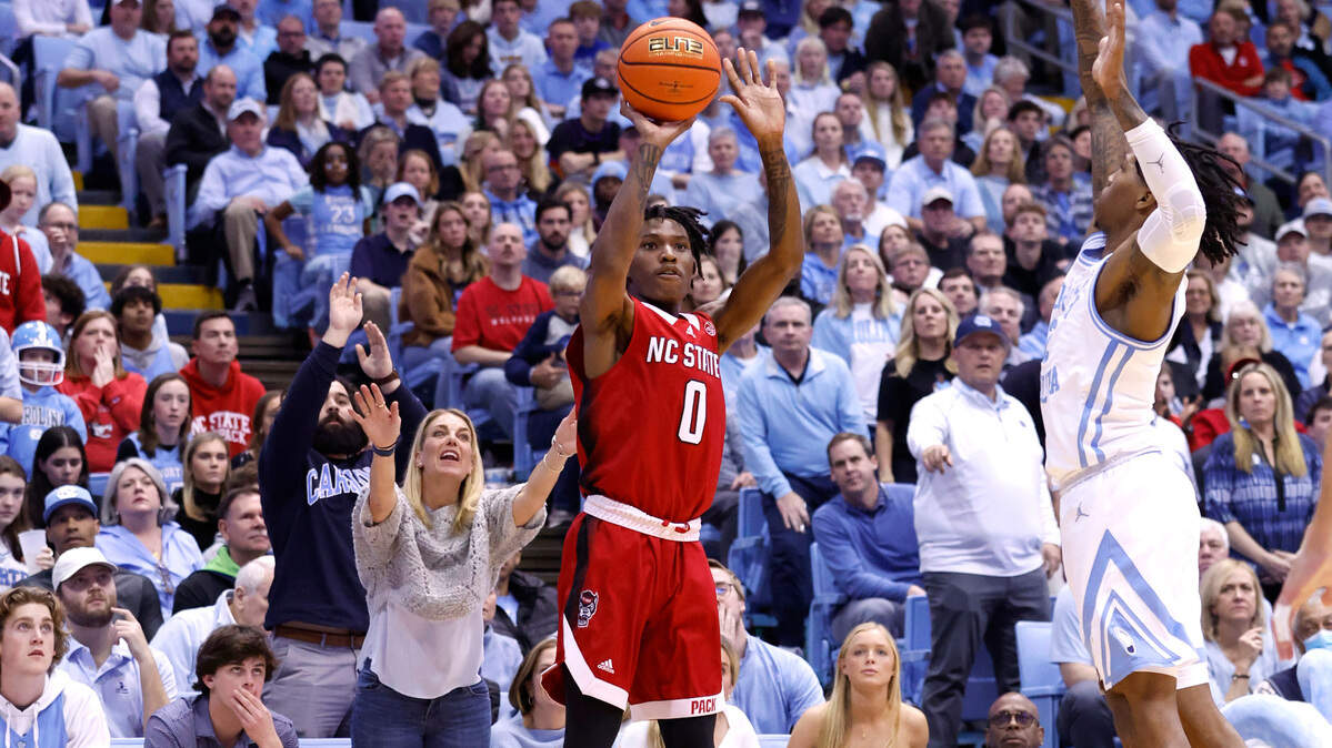 N.C. State’s Terquavion Smith (0) shoots as North Carolina’s Caleb Love (2) defends during the second half of UNC’s 80-69 victory over N.C. State at the Smith Center in Chapel Hill, N.C., Saturday, Jan. 21, 2023.