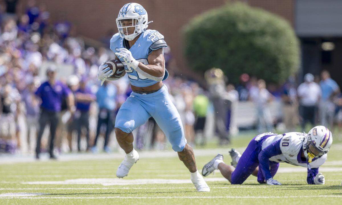 North Carolina running back Omarion Hampton (28) breaks away from James Madison defensive back Chris Shearin (10) for a 28-yard touchdown in the first quarter on Saturday, September 21, 2024 at Kenan Stadium in Chapel Hill, N.C.